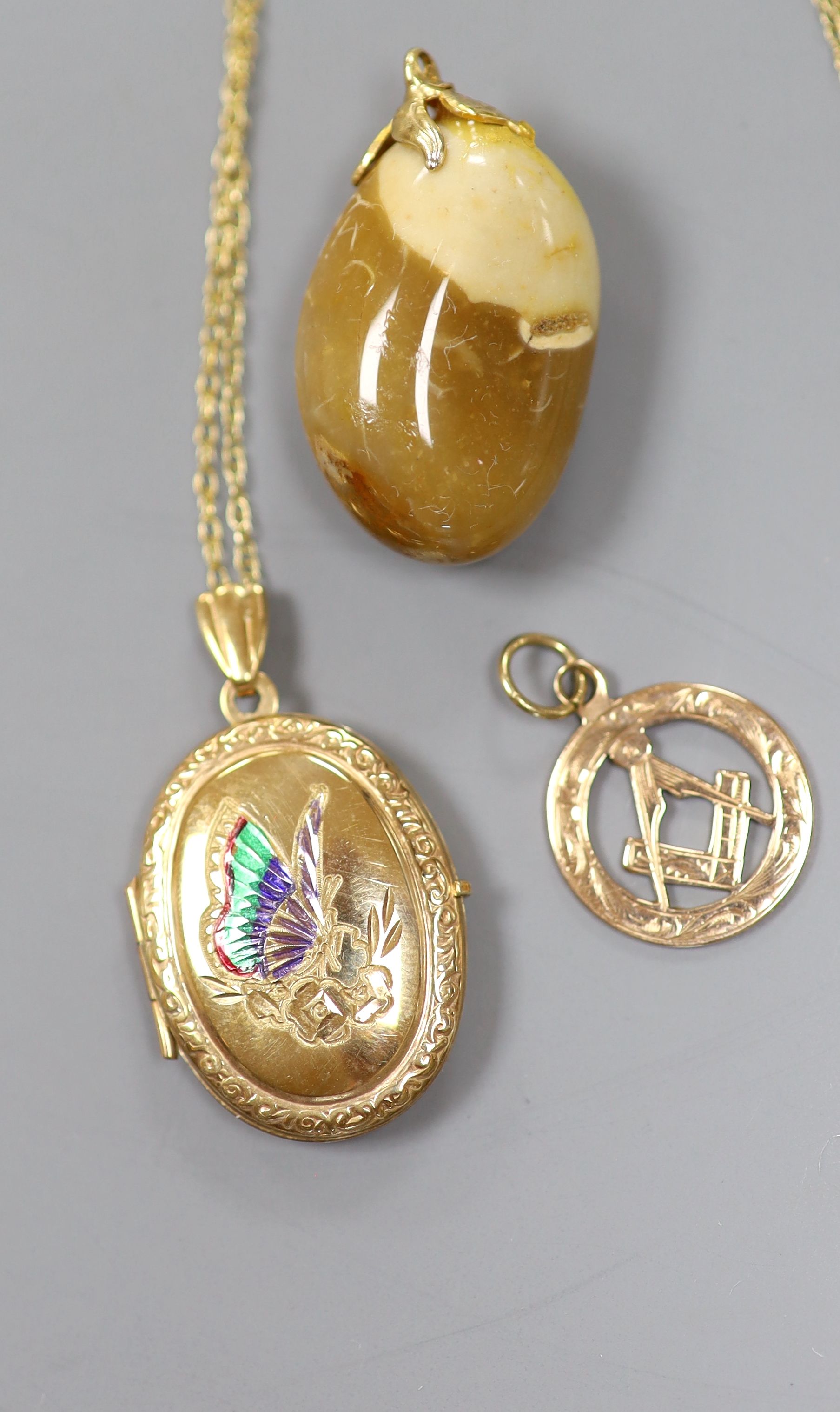 A 9ct gold Masonic watch fob, a 9ct gold locket and a hardstone pendant